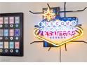 Fun Welcome to Las Vegas neon sign and framed poker chip collection add to the home's decor at 10733 Red Badge Ave, Las Vegas, NV 89166