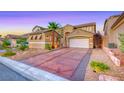 Attractive single-Gathering home featuring a two-car garage, desert landscaping, and a private driveway at 11334 Patores St, Las Vegas, NV 89141