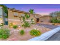 Well-kept yard with gravel landscaping surrounding a tan home featuring a tile roof at 11334 Patores St, Las Vegas, NV 89141