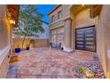 Inviting patio with tiled flooring, seating area, and a stylish entrance door at 11334 Patores St, Las Vegas, NV 89141