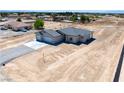 Expansive aerial view of a single story home showcasing a three car garage at 1800 Huckleberry St, Pahrump, NV 89048