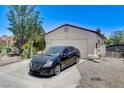 Exterior of the house featuring a two-car garage with a private driveway and manicured landscaping at 2402 Saguaro Point St, Las Vegas, NV 89115