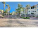 Terra Bella Condominiums view of community gate with landscaping and palm trees at 2555 Hampton Rd # 5104, Henderson, NV 89052