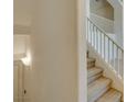 Bright staircase featuring white railings, neutral carpet, and a modern wall sconce at 2786 Fountain Ridge Ln, Henderson, NV 89074