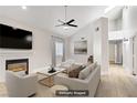 Bright living room features a fireplace, fan, and neutral-toned furniture for a cozy feel at 2925 Wigwam Pkwy # 1021, Henderson, NV 89074