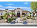 Inviting front entrance with double doors, desert landscaping, and a stone pathway to the home at 328 Hedgehope Dr, Las Vegas, NV 89183