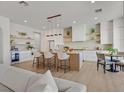 Modern kitchen features a large island with seating, stainless steel appliances, and stylish pendant lighting at 328 Hedgehope Dr, Las Vegas, NV 89183