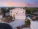 Beautiful aerial view of a two-story house with a pool and meticulously landscaped yard in a gated community at 352 Angels Trace Ct, Las Vegas, NV 89148