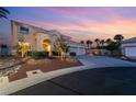 Charming home with landscaped yard, featuring a three-car garage, and a welcoming entrance at 352 Angels Trace Ct, Las Vegas, NV 89148