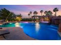 Stunning pool featuring a waterfall, integrated hot tub, and poolside cabana at 352 Angels Trace Ct, Las Vegas, NV 89148