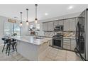 Modern kitchen with a large island, stainless steel appliances, and pendant lighting at 3591 Gloucester Gate St, Las Vegas, NV 89122