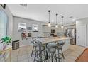 Contemporary kitchen featuring a central island with seating and modern light fixtures at 3591 Gloucester Gate St, Las Vegas, NV 89122