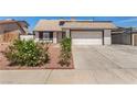 Exterior shot of single-story home featuring desert landscaping, a driveway, and an attached two-car garage at 3748 Silent Hill Dr, Las Vegas, NV 89147