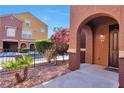 Arched entrance to a beautiful house with lovely landscaping at 3975 N Hualapai Way # 121, Las Vegas, NV 89129