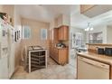 Bright eat-in kitchen featuring a tile floor and standard dishwasher and refrigerator at 3975 N Hualapai Way # 121, Las Vegas, NV 89129