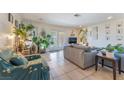 Inviting living room filled with natural light, tile floors, and ample space for plants and decor at 409 Antelope Way, Las Vegas, NV 89145