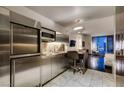 Modern kitchenette with stainless steel appliances, counter seating, and views at 4381 Flamingo Rd # 2010, Las Vegas, NV 89103