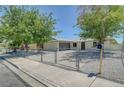 Well-maintained single-story home with a gravel front yard, chain-link fence, and two-car garage at 4424 Sunrise Ave, Las Vegas, NV 89110