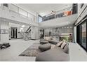 Expansive living room with soaring ceilings, modern furnishings, and a seamless indoor-outdoor flow at 5 Highland Cove Ln, Henderson, NV 89011