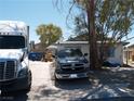 Modest single-story home with a truck and vehicle parked in the front at 5068 Killarney St, Las Vegas, NV 89122