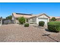 Inviting one-story home with a two car garage, desert landscaping, and solar panels on the roof at 5117 Axbridge Ct, North Las Vegas, NV 89031