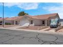 Well-maintained single-story house showcasing a two-car garage and desert landscaping at 519 Landra Ln, Henderson, NV 89015