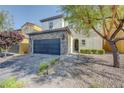 Charming two-story home featuring a stone accented facade and a well-maintained front yard at 599 Wounded Star Ave, Las Vegas, NV 89178