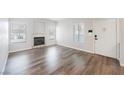 Bright living room featuring a tiled fireplace and wood-look flooring at 6006 Vegas Dr, Las Vegas, NV 89108