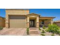 Stunning curb appeal with desert landscaping, brick walkway and entryway pillars with stone accents at 6098 Avery Pointe St, Las Vegas, NV 89166