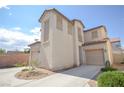 Two-story stucco home featuring dual garages and desert landscaping at 6098 Darkfeather Way, Las Vegas, NV 89139
