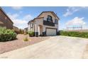 Inviting two-story home with a spacious driveway and manicured landscaping at 648 Jumbled Sage Ct, Henderson, NV 89015