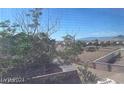 Scenic neighborhood view featuring houses, trees, and mountains on the horizon at 648 Jumbled Sage Ct, Henderson, NV 89015