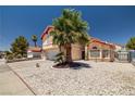 Beautifully landscaped home with a mature palm tree, rock garden, and well-maintained exterior at 6746 Shelter Ln, Las Vegas, NV 89103