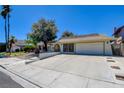 Charming single-story home with desert landscaping, long driveway, and an attached two-car garage at 6822 Garden Grove Ave, Las Vegas, NV 89103