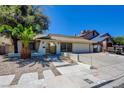 Charming single-story home with desert landscaping, long driveway, and an attached two-car garage at 6822 Garden Grove Ave, Las Vegas, NV 89103