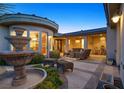 Charming outdoor patio with comfortable seating and a decorative fountain at 69 Tapadero Ln, Las Vegas, NV 89135