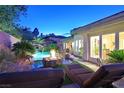 Stunning outdoor space with a rock waterfall, pool, and fire pit at 69 Tapadero Ln, Las Vegas, NV 89135