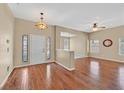 The living room features hardwood floors, a ceiling fan, and decorative stained glass windows by the entry at 6920 Haven Hollow Ave, Las Vegas, NV 89130