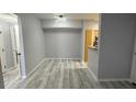 Open floor plan living and dining room with wood look floors at 6955 N Durango Dr # 1013, Las Vegas, NV 89149