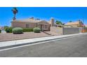 Desert-landscaped home with a brick-lined walkway leading to the front door and a well-kept lawn at 7019 Shadow Crest Dr, Las Vegas, NV 89119