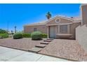 Inviting home with desert landscaping, complemented by a stone walkway to the front door at 7019 Shadow Crest Dr, Las Vegas, NV 89119