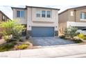 Charming two-story home featuring a well-maintained front yard, a paved driveway, and an attached garage at 7211 Alabaster Peak St, Las Vegas, NV 89166