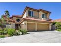 Expansive home with a red tile roof, three-car garage, and a lush green lawn at 7889 Rancho Mirage Dr, Las Vegas, NV 89113