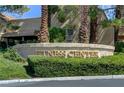 Community fitness center sign surrounded by lush greenery and mature palm trees on a sunny day at 7889 Rancho Mirage Dr, Las Vegas, NV 89113