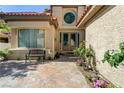 Inviting front entrance with a charming bench and meticulously landscaped garden at 7889 Rancho Mirage Dr, Las Vegas, NV 89113