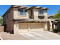 Two-story home featuring a three-car garage and desert landscaping at 9052 Pine Mission Ave, Las Vegas, NV 89143