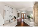Stunning foyer with wood floors, neutral paint, and a bench seat at 9155 Harvest Homes St, Las Vegas, NV 89123