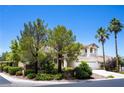 Lovely home featuring a well-maintained front yard, mature trees, and a three-car garage, creating a welcoming atmosphere at 9155 Harvest Homes St, Las Vegas, NV 89123