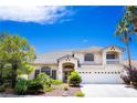 Inviting two-story home boasts a lush front yard and a spacious three-car garage, perfect for a growing Gathering at 9155 Harvest Homes St, Las Vegas, NV 89123