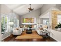 Cozy living room with vaulted ceilings, a fireplace, and hardwood floors at 9155 Harvest Homes St, Las Vegas, NV 89123
